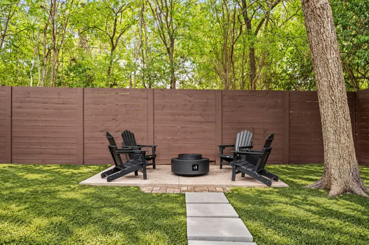 Backyard fire pit patio with lounge chairs