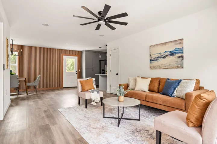 Living room with leather sofa and wood slat wall